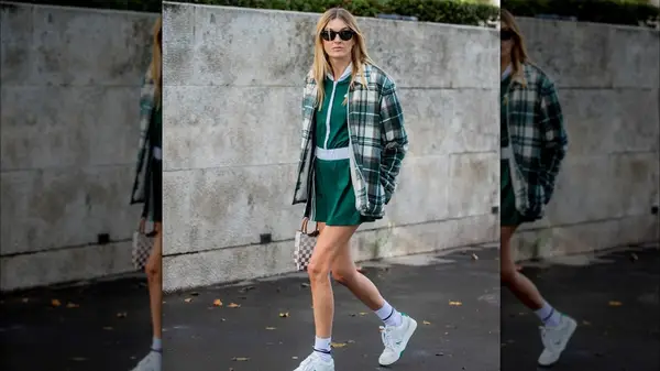 A woman in a plaid shacket and shorts 