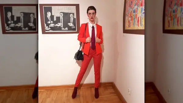 Person in red suit and tie