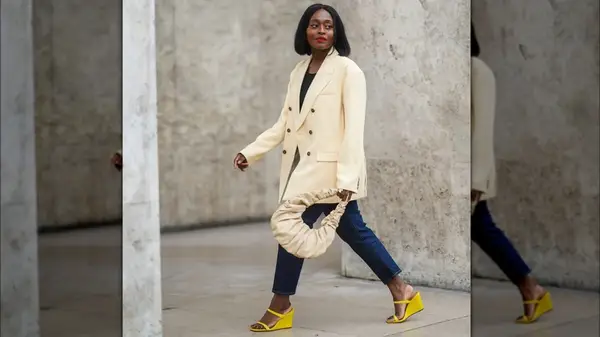 A woman in an off-white blazer 