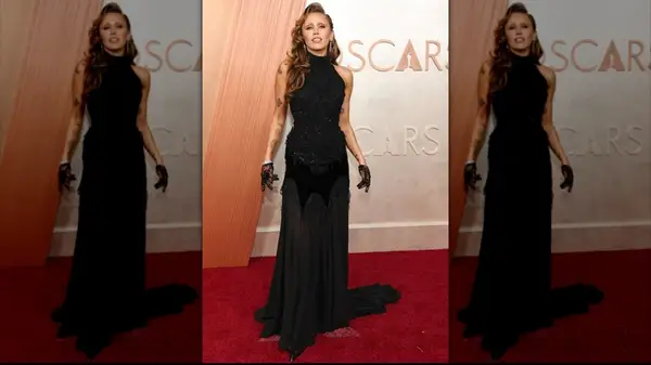 Miley Cyrus posing in a custom black gown at the 2025 Academy Awards