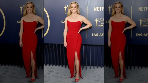 Reese Witherspoon smiling while wearing a vibrant red dress
