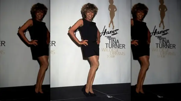 Tina Turner in posing in a black dress