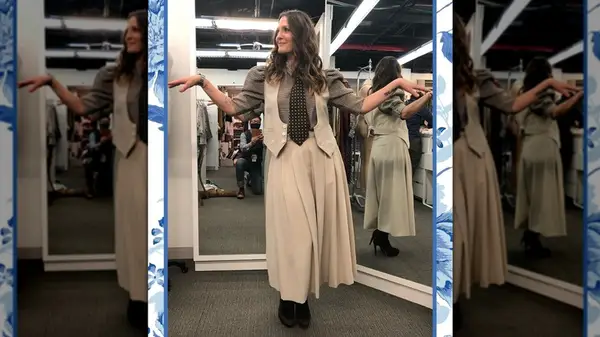 Drew Barrymore posing in a biege skirt and vest at The Drew Barrymore Show