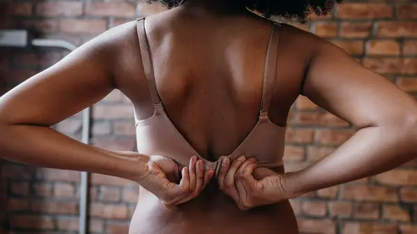 Woman unclasping bra