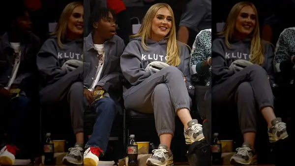 Adele at a basketball game in a gray sweatsuit