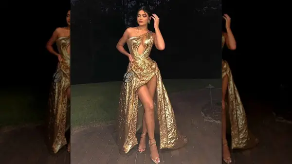 Kylie Jenner wearing a gold ball gown with cut outs