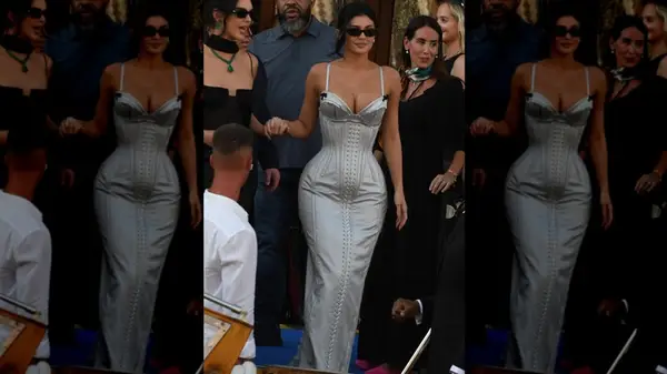 Kylie Jenner wearing a form-fitting silver gown