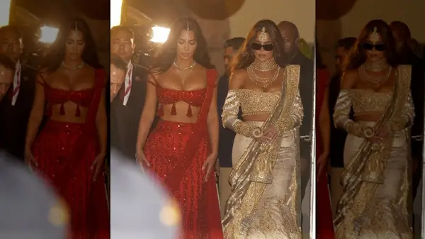 Kim and Khloe Kardashian walking while wearing lehengas