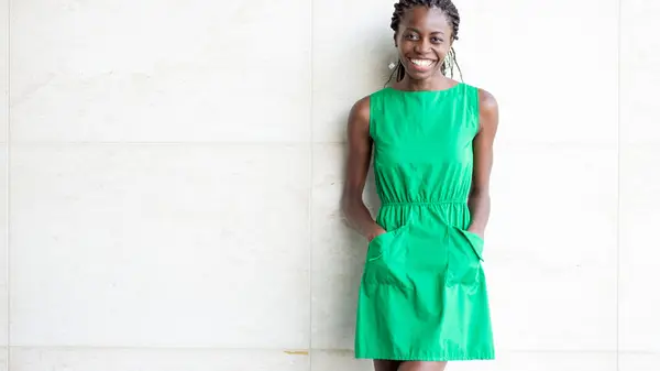 Women with hands in dress pockets