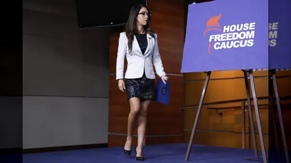 Lauren Boebert on stage in a short, black dress