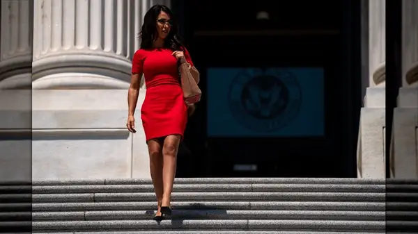 Lauren Boebert walking down stairs in a red dress
