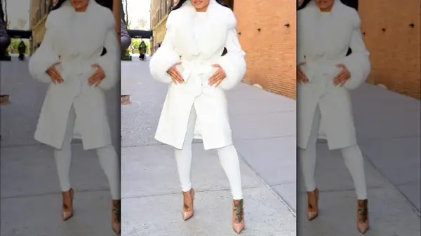 model in white with leggings and pink heels