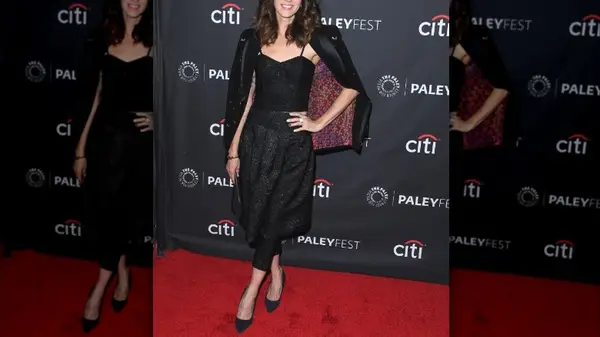 model in black with leggings and heels