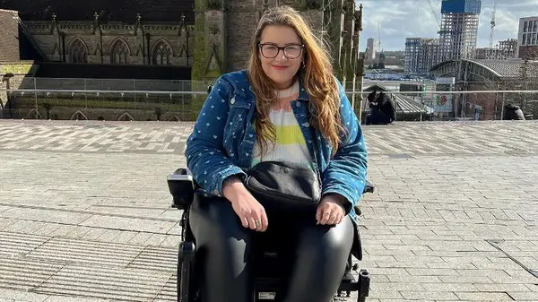 Woman iin wheelchair outside smiling