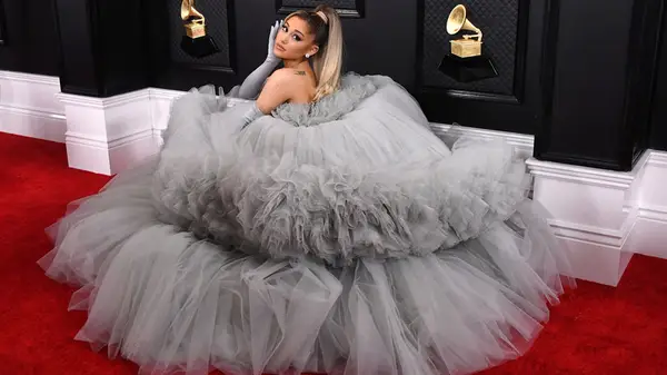 Ariana Grande posing in a light gray-blue ball gown at the 2020 Grammys