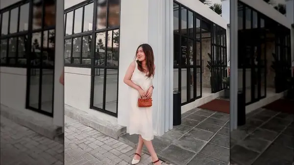 Woman holding small metallic bag