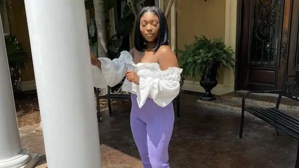 Woman wears digital lavender trousers