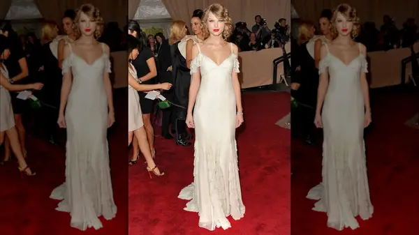 Taylor Swift on the red carpet in a white, off-the-shoulder gown
