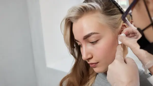 Person getting ears pierced