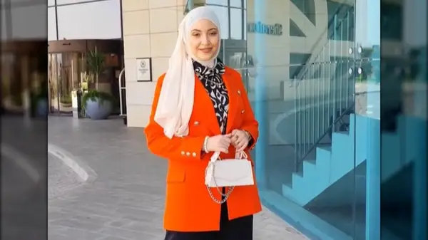 Woman in an orange blazer
