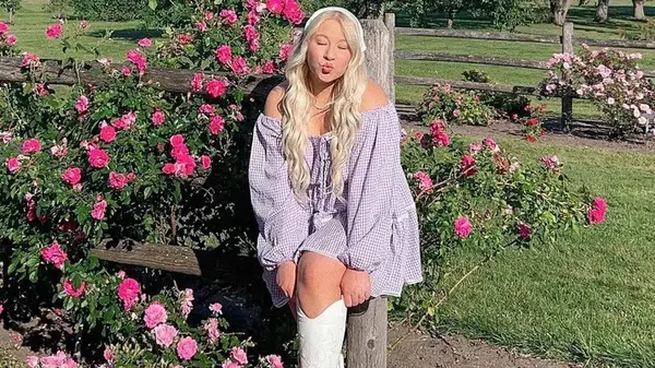 Woman in a gingham dress and boots