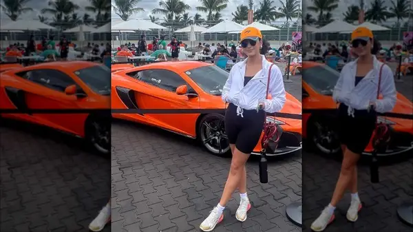 Woman posing by a car