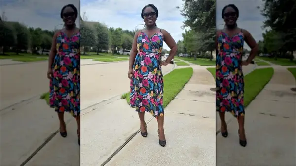 Black woman wearing a floral wrap dress in black heels