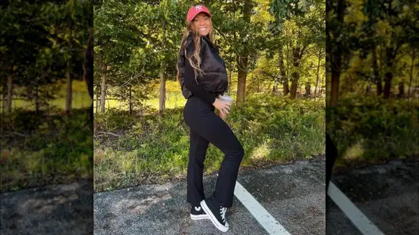 Natalie Bertolone poses in flared pants 