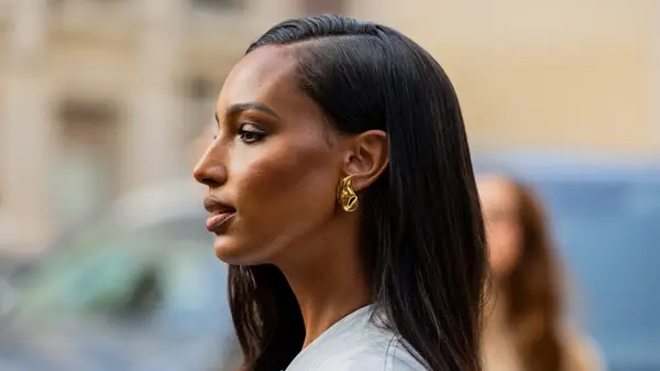 A woman in yellow gold earrings 