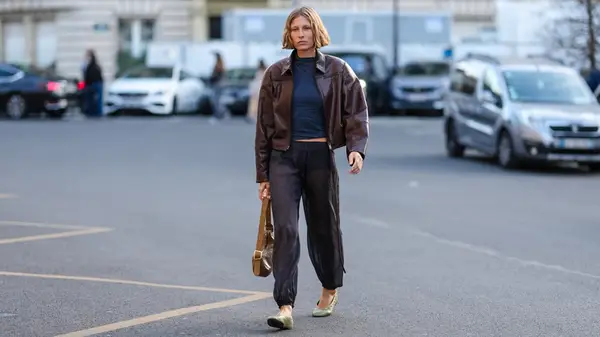 Guest at Paris Fashion Week wearing ballet flats and black pants