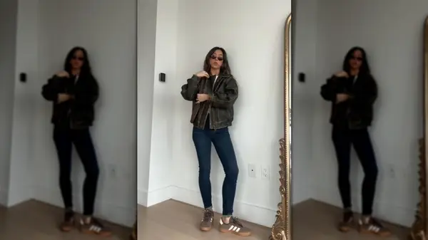 TikToker styling brown sneakers with skinny jeans and a leather jacket