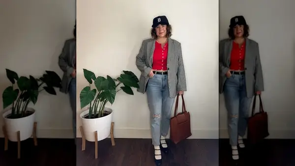 Woman wearing a bright red top, skinny jeans, and black Mary Janes