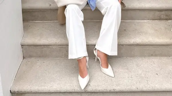 woman wearing white pumps