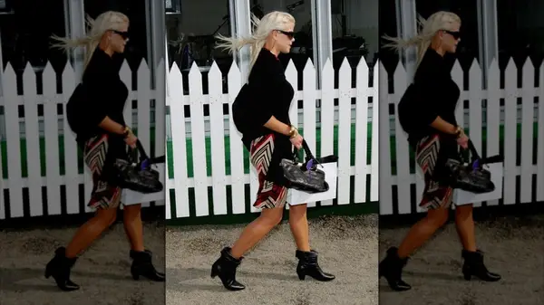 Elin Nordegren wearing a black cardigan over a dress