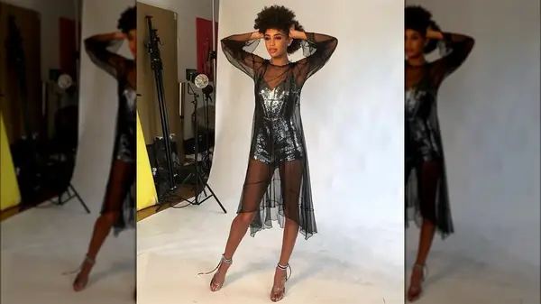 Woman in sheer dress and sparkle bodysuit