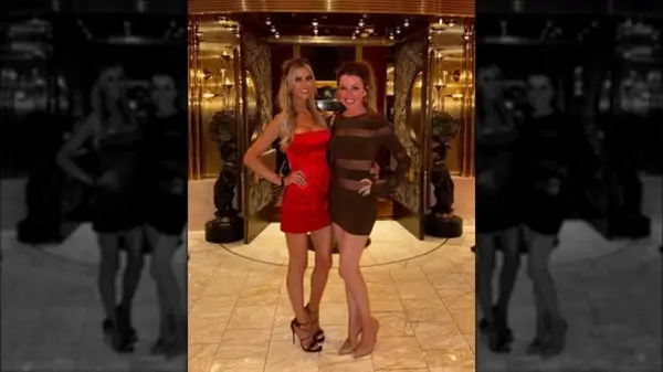 Christina Haack in a satin red dress standing with a friend in July 2024