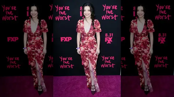 Mikey Madison posing in a floral maxi dress at an FX premiere