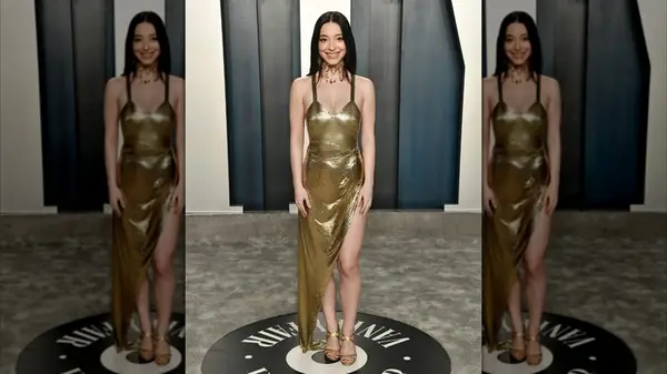 Mikey Madison smiling in a gold dress at the 2020 Vanity Fair Oscar Party