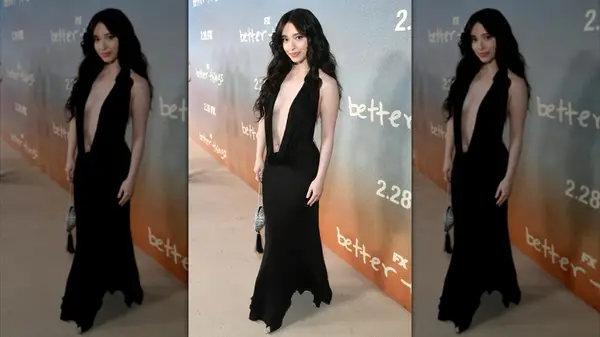 Mikey Madison posing in a black dress with a plunging neckline