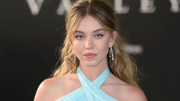 Sydney Sweeney on the red carpet in a blue dress