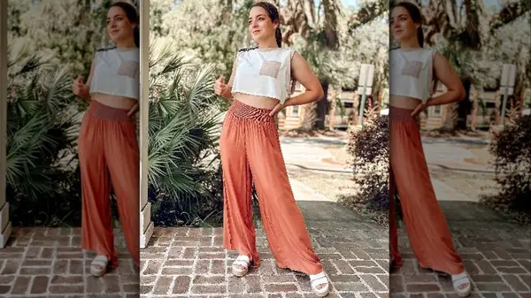 Woman posing outside in flowy pants