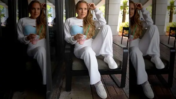 Woman in white pants and sneakers with starbucks cup