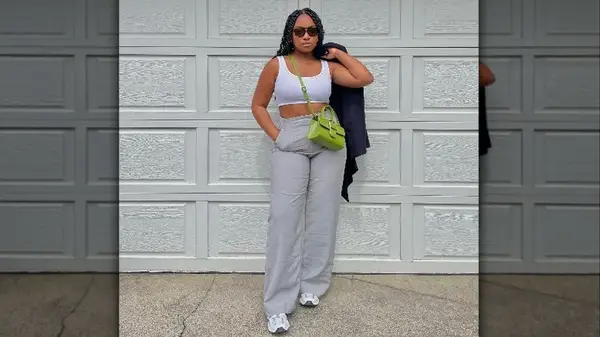 Woman posing by garage door in crop top 