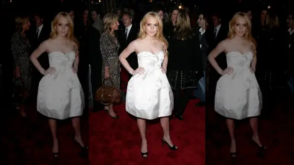 Linday Lohan on the red carpet in a white dress with a poufy skirt
