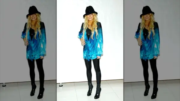 Lindsay Lohan wearing an oversized blue shirt over black leggings