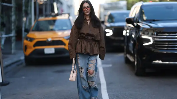 Woman wears ripped denim jeans