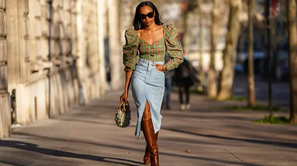 A woman wearing a denim midi skirt 
