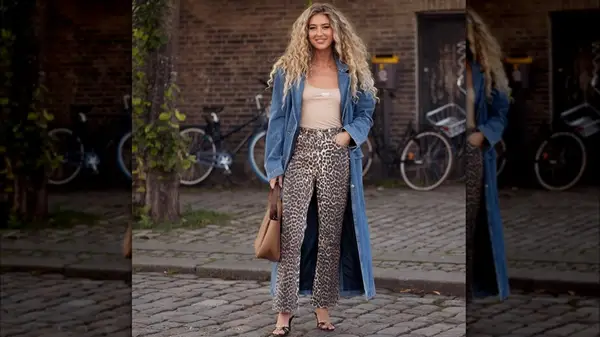 A woman in a denim trench coat 