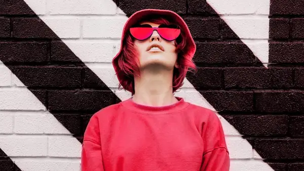 Woman wearing heart shaped sunglasses