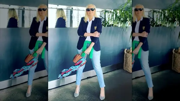 A woman posing with a scarf on her bag